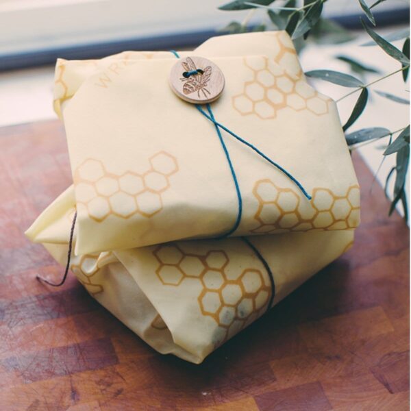 Beeswrap brand sandwich wrap with honeycomb print; use the string and bee button to secure food inside