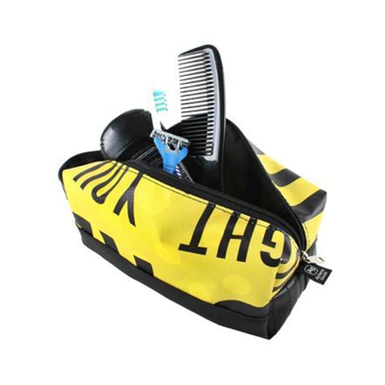 Alchemy Goods dopp kit with zippered closure shown holding razor, comb, and toothbrush