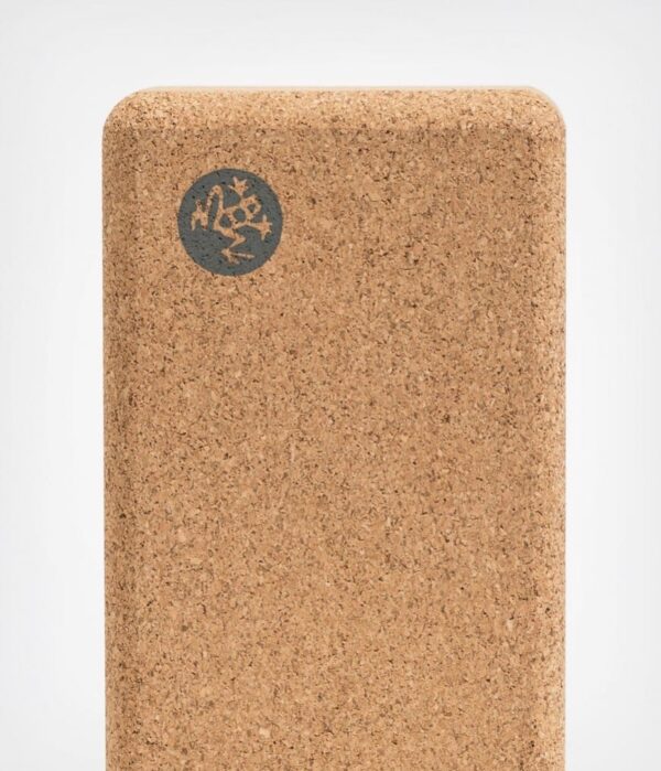 Close-up of Manduka brand travel yoga block, made with a lighter weight and sustainable cork material