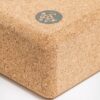 Close-up of corner of Manduka brand travel yoga block, made with a lighter weight and sustainable cork material
