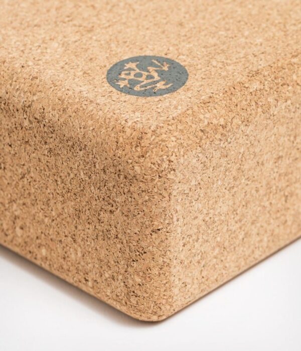 Close-up of corner of Manduka brand travel yoga block, made with a lighter weight and sustainable cork material