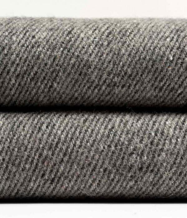 Close-up of wool fibers of the Manduka brand wool blanket in sediment gray; made with 100% recycled fibers