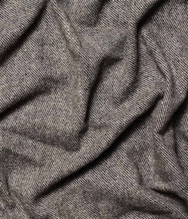 Close-up of Manduka brand wool blanket in sediment gray; made with 100% recycled fibers