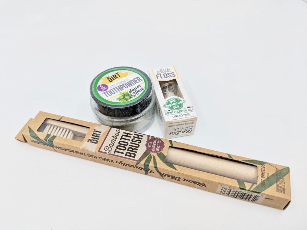 The Dirt brand green bamboo toothbrush, all natural Super Mint tooth powder, and biodegradable silk floss.