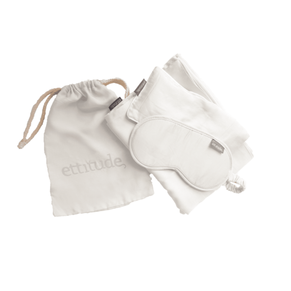 Three piece organic bamboo sleep travel kit made by Ettitude brand includes - white organic bamboo eye mask, white organic bamboo eye pillow, and white organic bamboo pillow case.  All of which fits neatly inside small white Ettitude brand pull string bag.