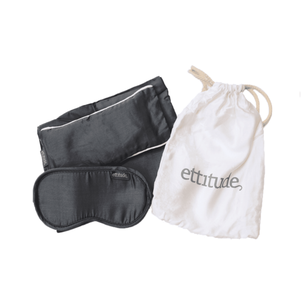 Three piece organic bamboo sleep travel kit made by Ettitude brand includes - grey organic bamboo eye mask, grey organic bamboo eye pillow, and grey organic bamboo pillow case.  All of which fits neatly inside small white Ettitude brand pull string bag.