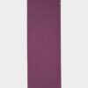 Manduka brand natural rubber 4mm yoga mat in acai purple; shown unrolled