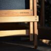 Close up display of MADE IN USA stamped on underside of eco friendly Blue Ridge Chairs brand American ash Blue Ridge forest green camping chair.