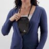 Female wearing an eco friendly Eagle Creek brand black natural silk undercover neck wallet around her neck.