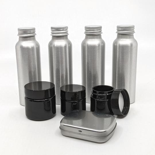 Aluminum bottles and recycled plastic jars in TSA 3-1-1 travel toiletry container set