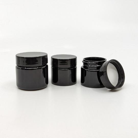 View of recycled black plastic jars in TSA-Friendly toiletry container set