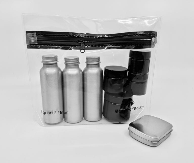 Reusable sustainable TSA friendly tin and plastic containers pictured inside of transparent leak proof Eagle creek brand bag, part of TSA-Friendly Travel Container Set.