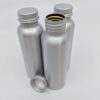 Close up display of earth friendly reusable tin container bottles that make up Reusable TSA-Friendly Travel Container Set.