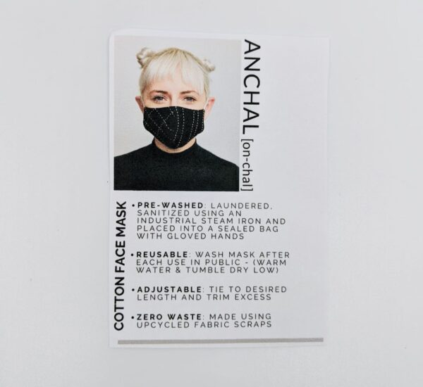 White information card with product description and photo of female wearing Anchal brand face mask.