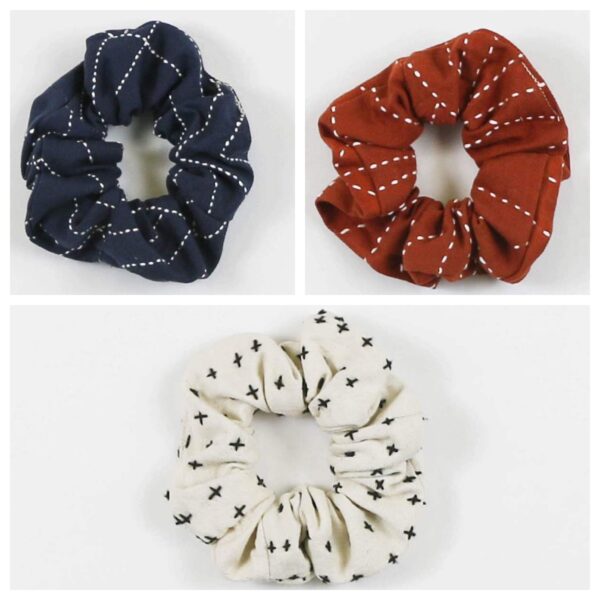 Three pack of earth friendly Anchal brand scrunchies made from fair trade organic cotton comes in rust, bone and blue colors scrunchies.
