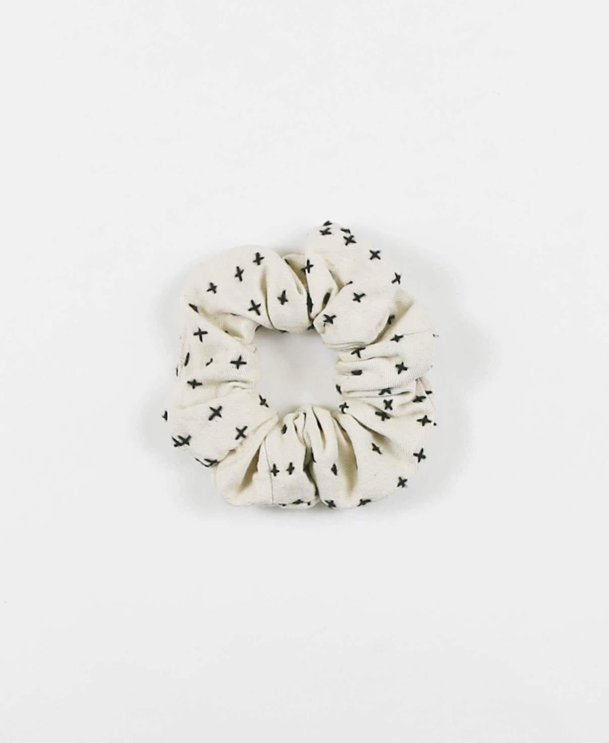 Overhead product display of environmentally friendly fair trade organic cotton Anchal brand scrunchie bone color.