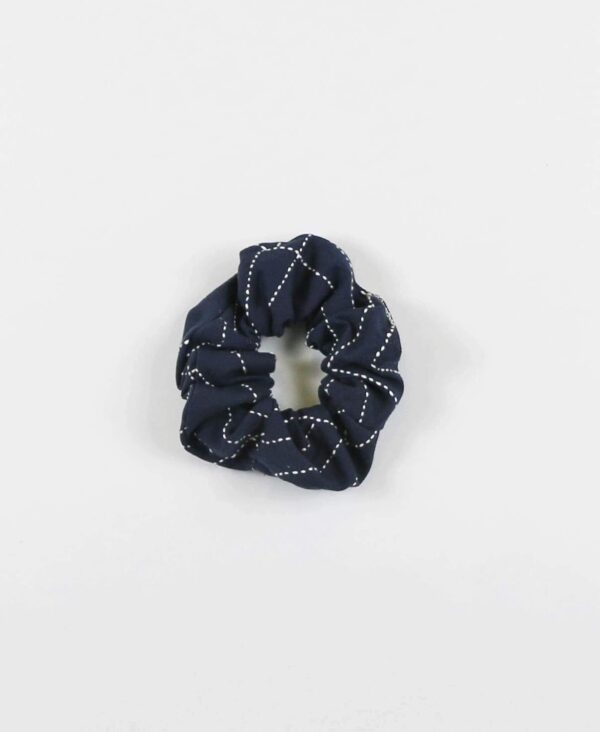 Overhead product display of environmentally friendly fair trade organic cotton Anchal brand scrunchie navy color.