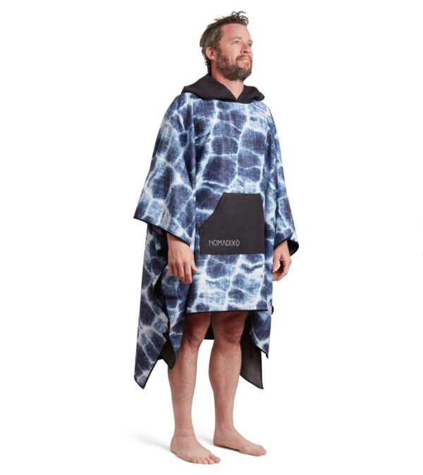 Man wearing eco-friendly Agua Blue Poncho Towel from Nomadix