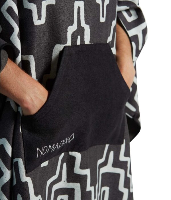 Hands in pocket of recycled Teton Black Poncho Towel for scuba, swim, travel, van life and more.