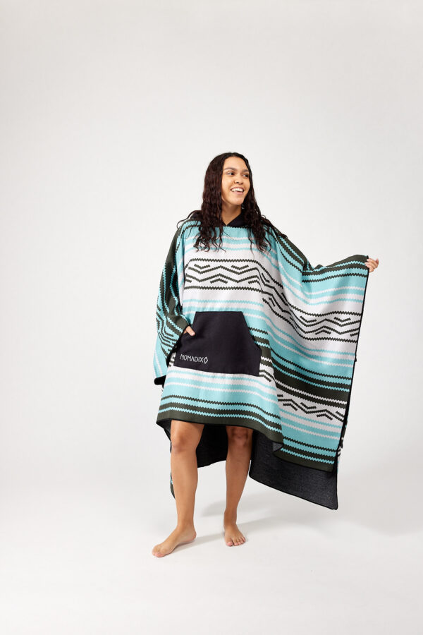 Woman in Baja Aqua Poncho Towel for surf, swim, pool, beach, lake and more.