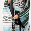Woman buttoning side of recycled Baja Aqua Poncho Towel for swim, beach, scuba and travel