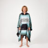 Man wearing one size Baja Aqua Poncho Towel for travel
