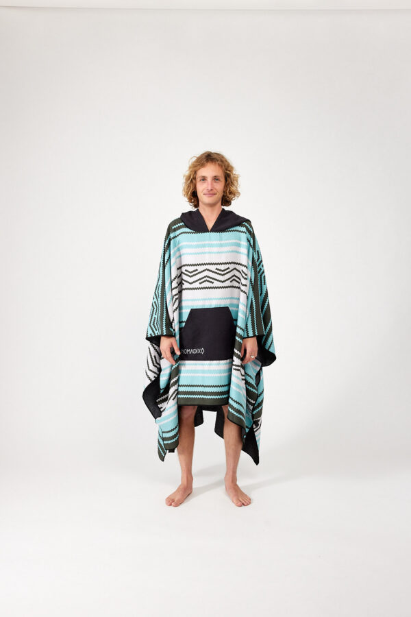 Man wearing one size Baja Aqua Poncho Towel for travel