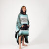 Man with hands in pocket and hood of recycled Baja Aqua Poncho Towel