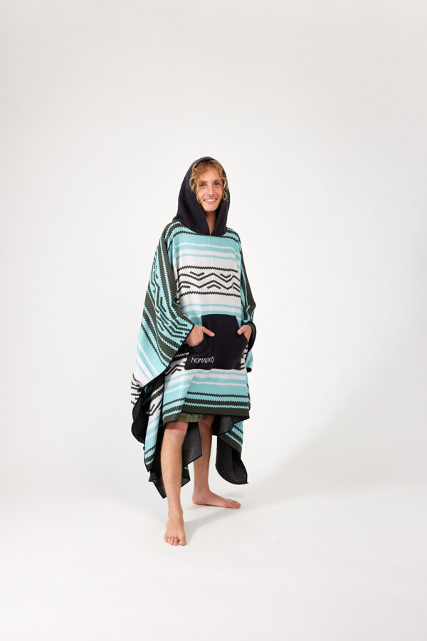 Man with hands in pocket and hood of recycled Baja Aqua Poncho Towel