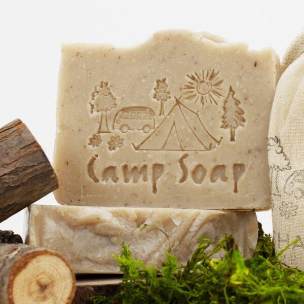 Up-close photo of the all-natural camp soap by Fire Lake Soapery with camping scene imprinted into the soap.