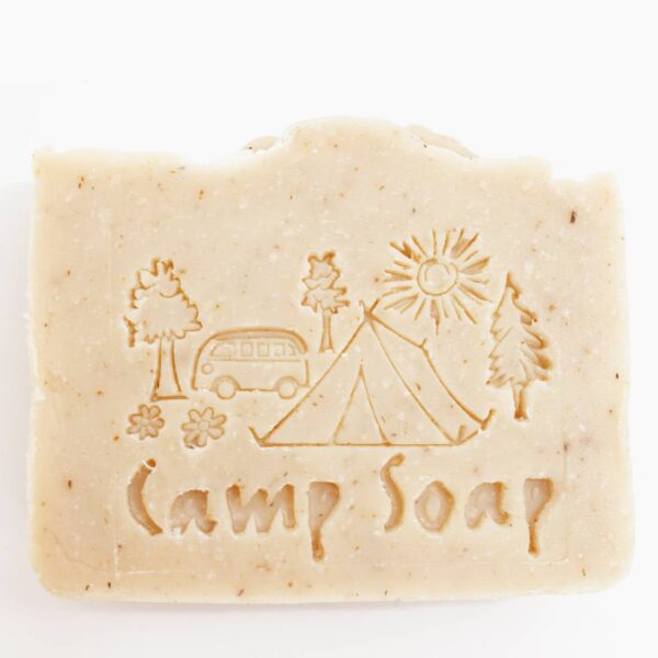 Up-close photo of the all-natural camp soap by Fire Lake Soapery with camping scene imprinted into the soap.