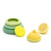 A set of green reusable food savers, by Food Huggers, shown keeping a lemon sealed and fresh.