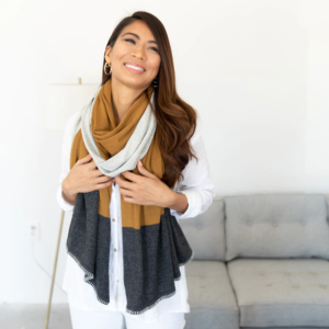 Woman wearing sustainable colorblock travel scarf from Zestt Organics