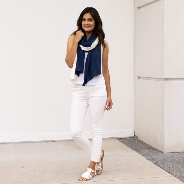 Woman wearing fair trade, organic cotton travel scarf in navy and cream