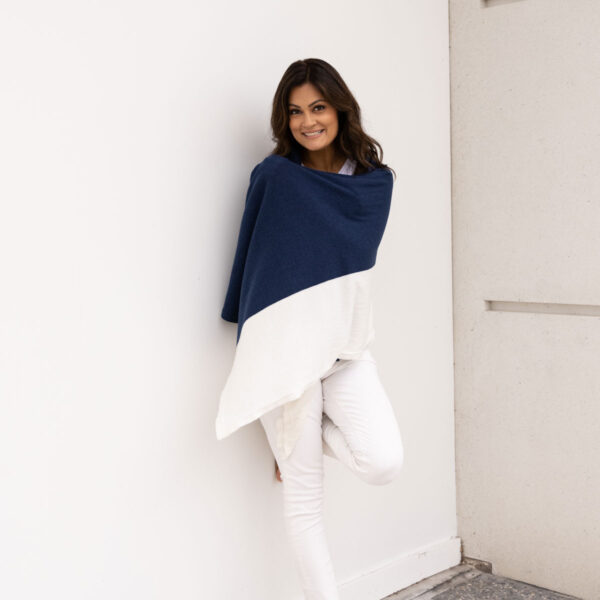 Woman wrapped in organic cotton dreamsoft travel scarf from Zestt Organics in navy colorblock