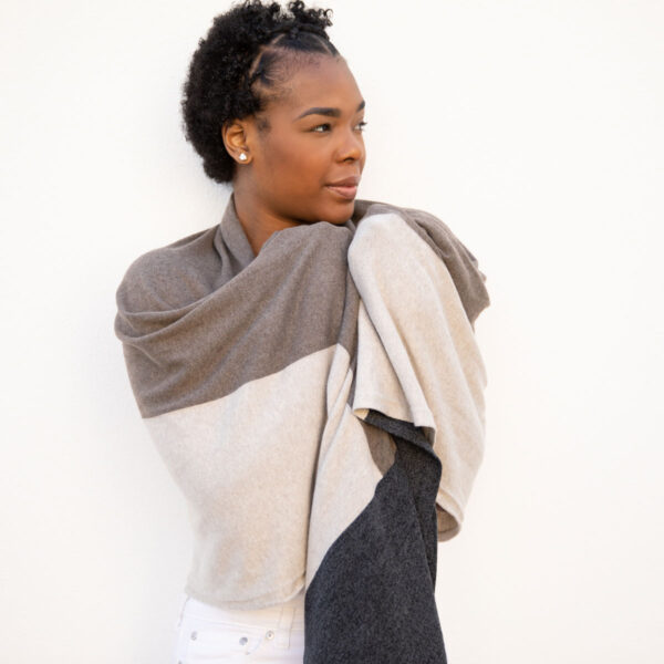 Woman wrapped in brownstone colorblock, fair trade, organic cotton travel scarf