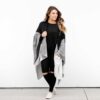 Woman in black colorblock organic cotton blanket travel wrap from zestt organics