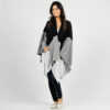 Woman wearing eco-friendly, organic cotton travel blanket cape from Zestt Organics in black and grey colorblock