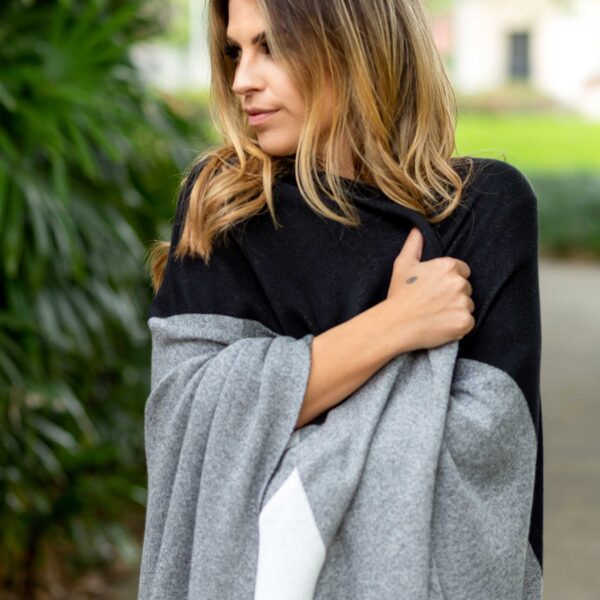 Woman in one-size travel blanket wrap from women-owned business Zestt Organics