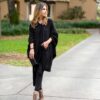 Woman in eco-friendly, black organic cotton travel wrap and cape