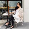 Woman traveling in ivory colorblock organic cotton one-size women's wrap