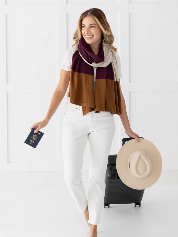Woman traveler wearing organic cotton scarf for sustainable travel