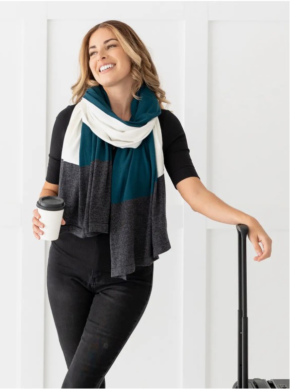 Female traveler with sustainable blanket scarf