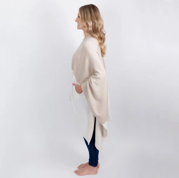 Side view of woman in ivory and tan colorblock organic cotton travel wrap