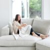 Woman on couch in organic cotton sustainable wrap