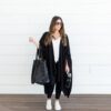 A model is out running errands while wearing the travel wrap made by Zestt Organics. This wrap is like wearing a blanket while on-the-go.