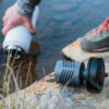 A Mizu water bottle being filled up in a river. The Adventure purifier allows hikers to use fresh water sources to purify water while in the wilderness.