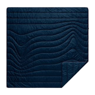 The original Rumpl 2 person puffy blanket in deepwater blue is made from 100% post-consumer recycled materials. Shown with ripstop fabric and wavy stitching.