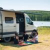 RV and camper van with group sitting on Rainbow Fade Everywhere MAt
