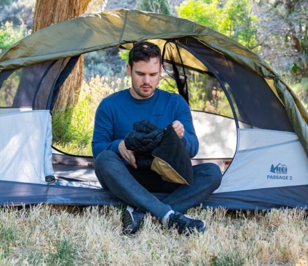 Man in camping tent with eco-friendly stuffable pillowcase